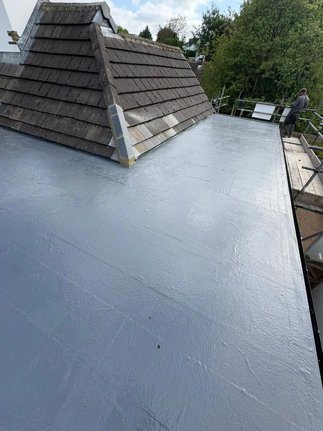 A flat roof being installed on a house.