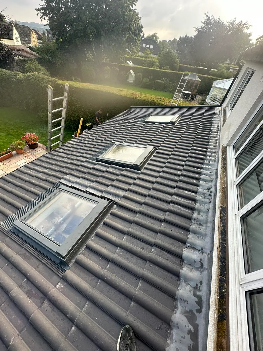 a house with a metal roof with a skylight